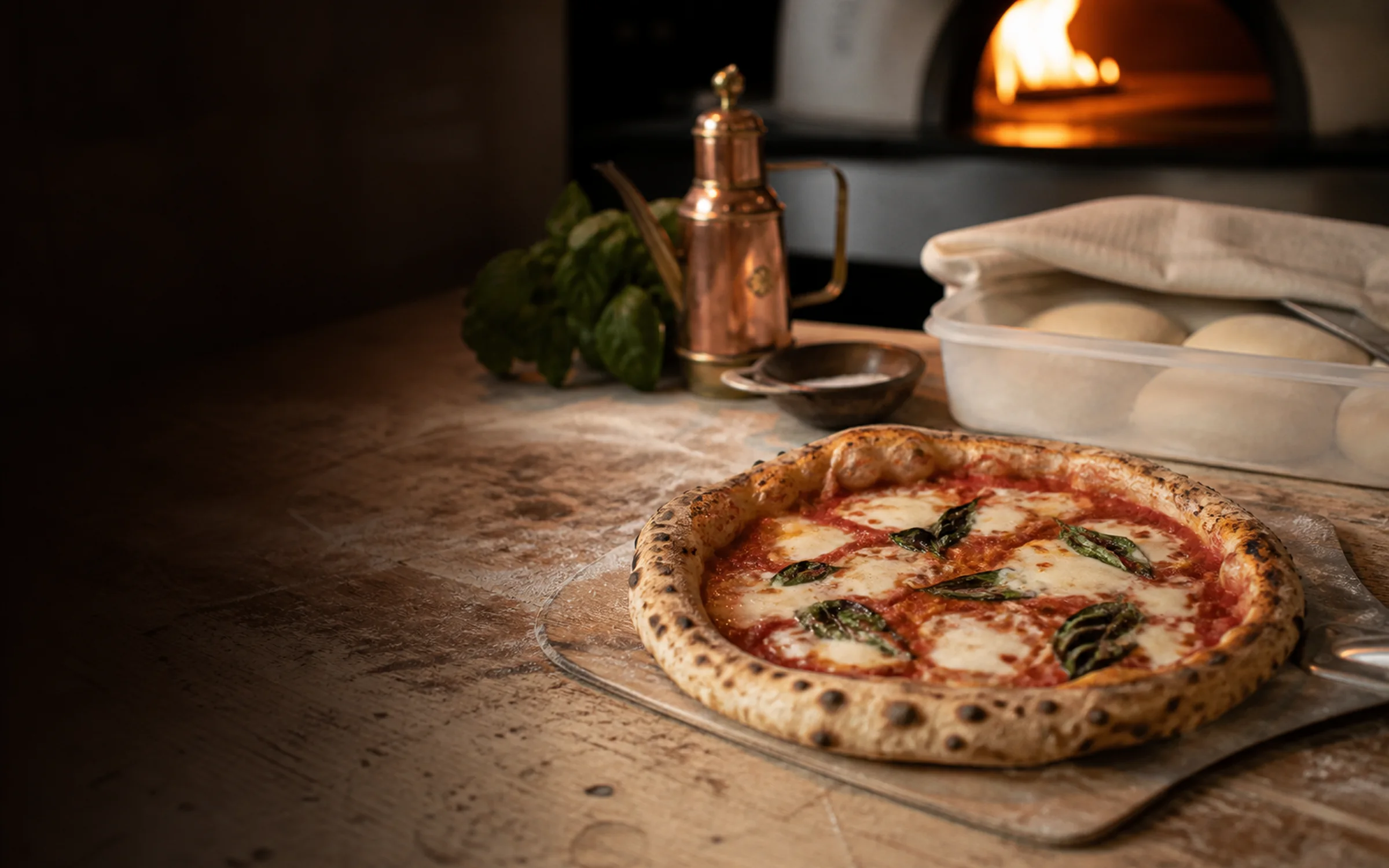 Finished pizza with prepared dough in a warm pizza-making workspace