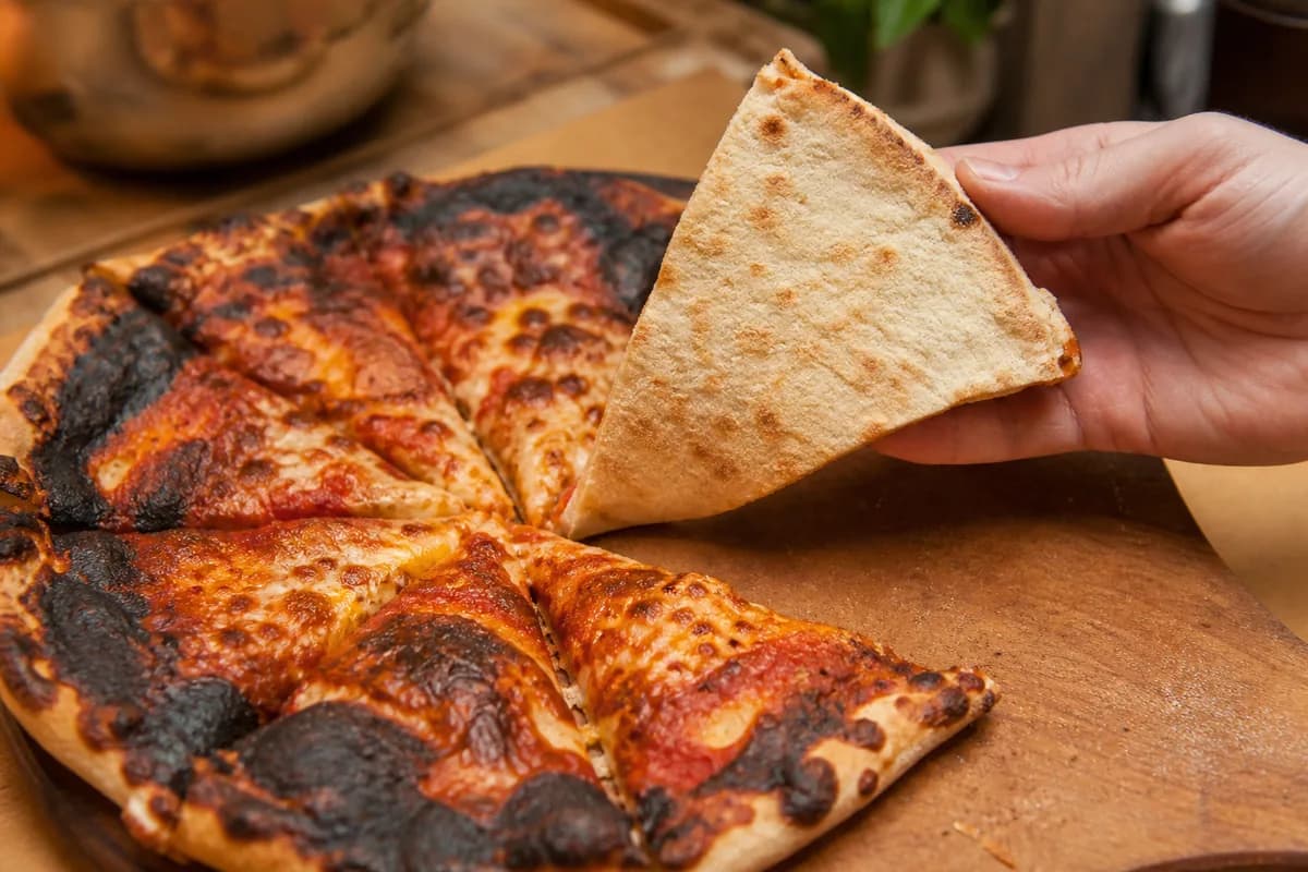 Pizza with top color developing before the base has baked through.